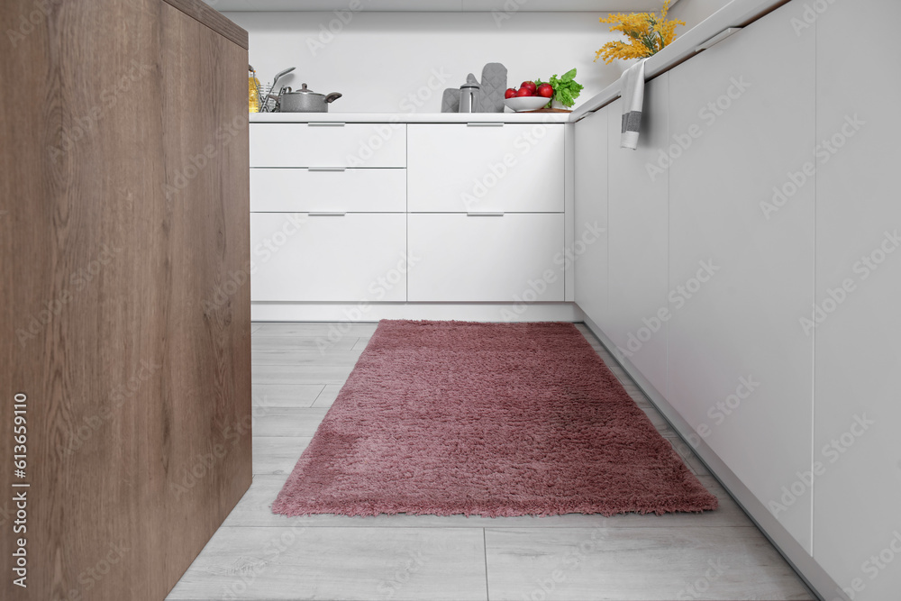 Stylish brown carpet in interior of modern kitchen