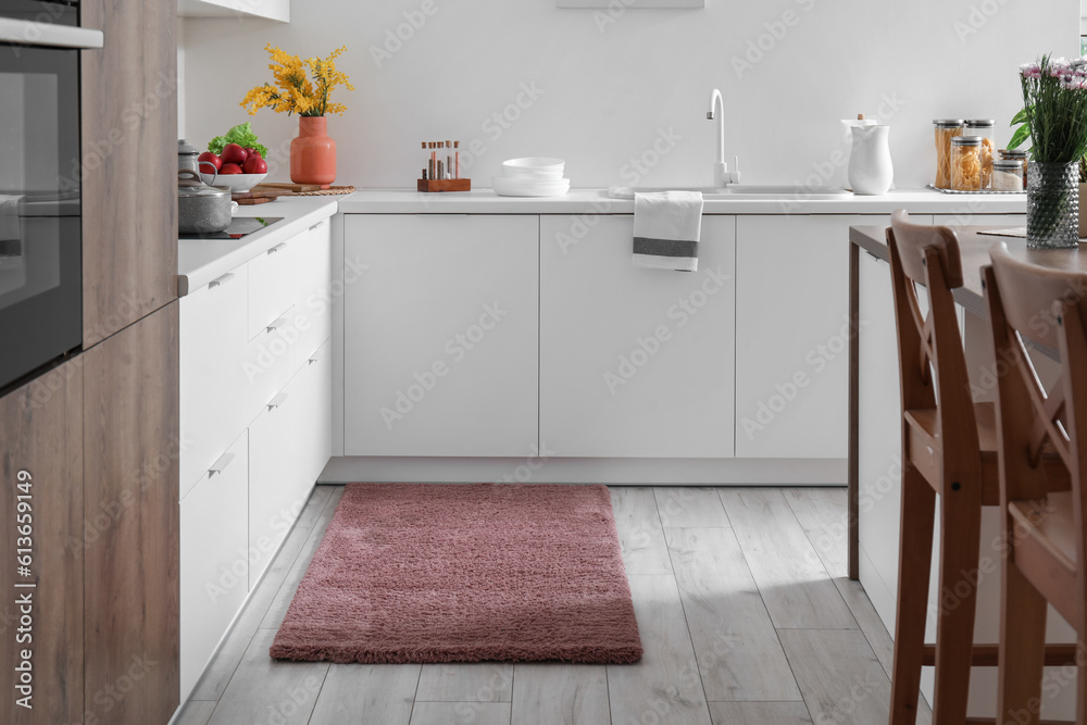 Stylish brown carpet in interior of modern kitchen