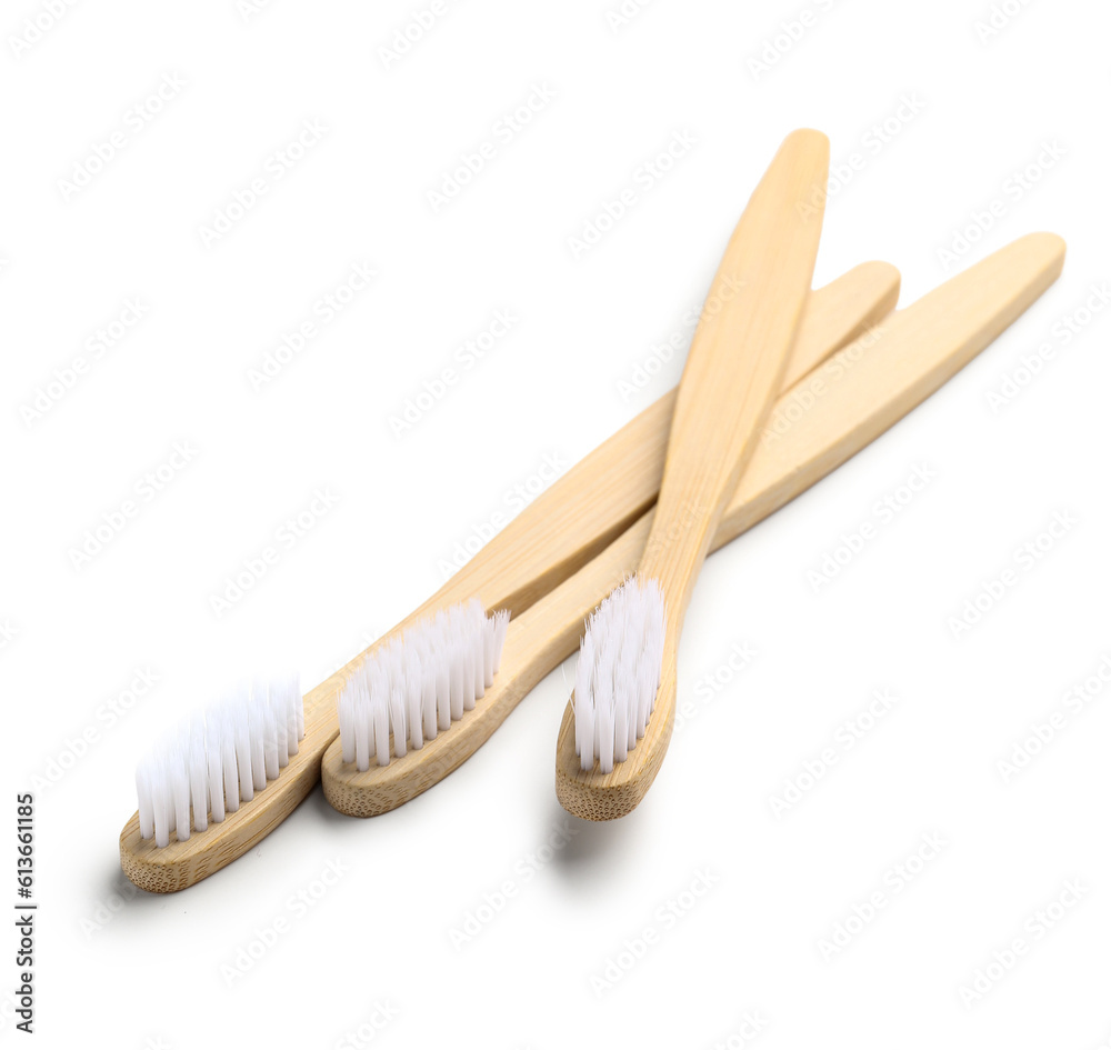 Bamboo toothbrushes on white background