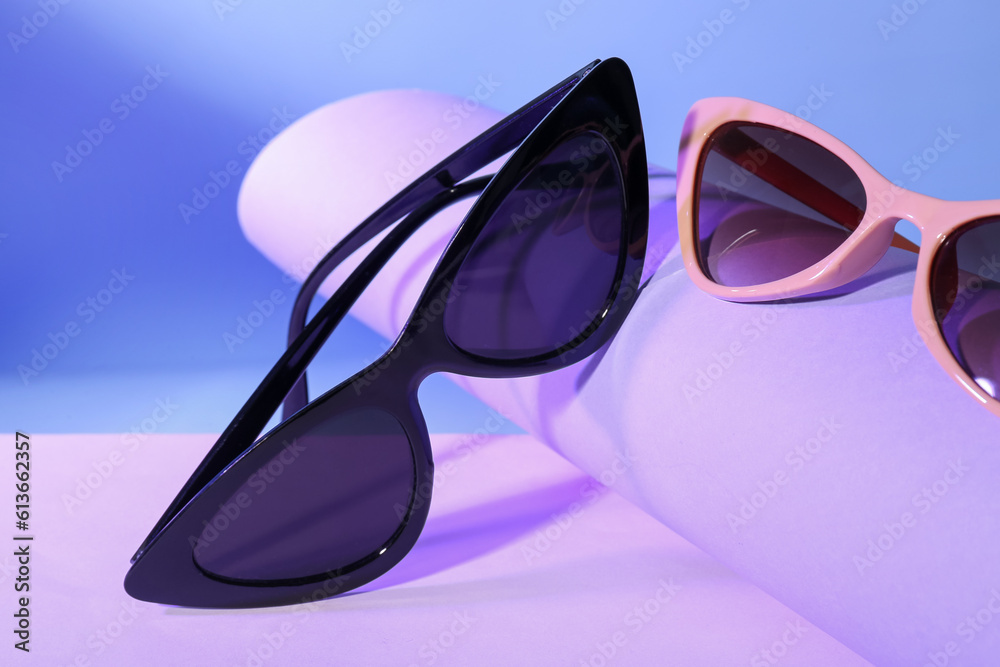 Different stylish sunglasses on colorful background