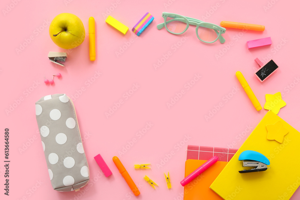 Frame made of fresh apple, eyeglasses and different stationery on pink background