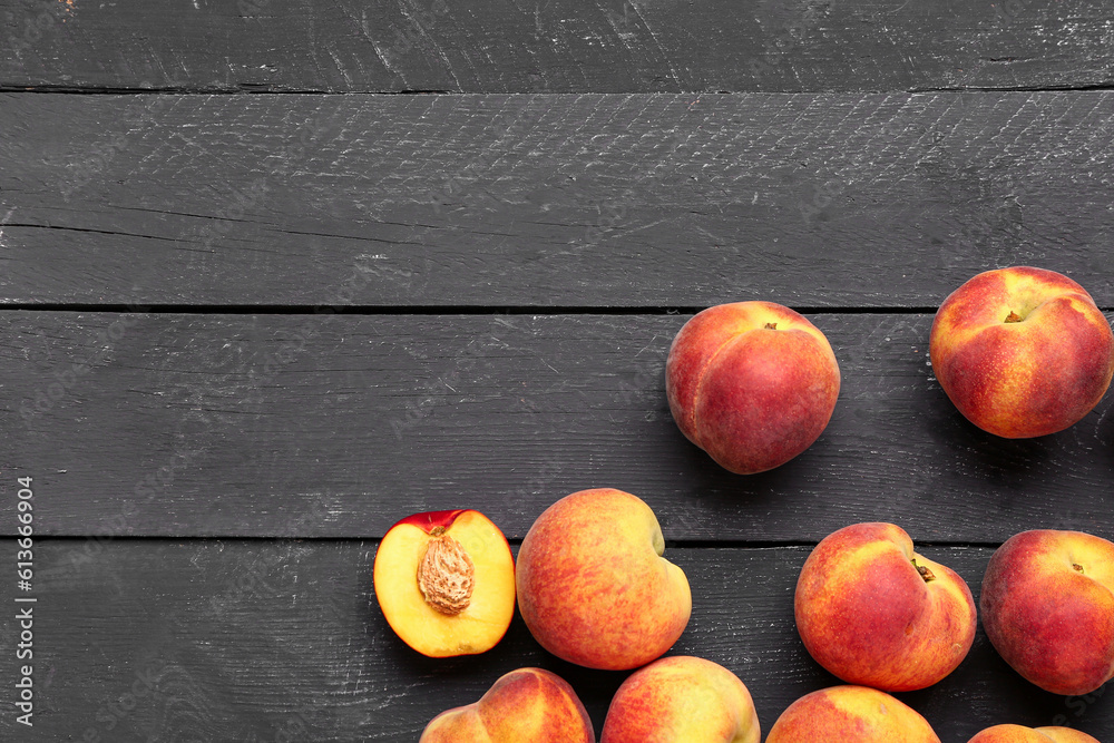 Many sweet peaches on black wooden background