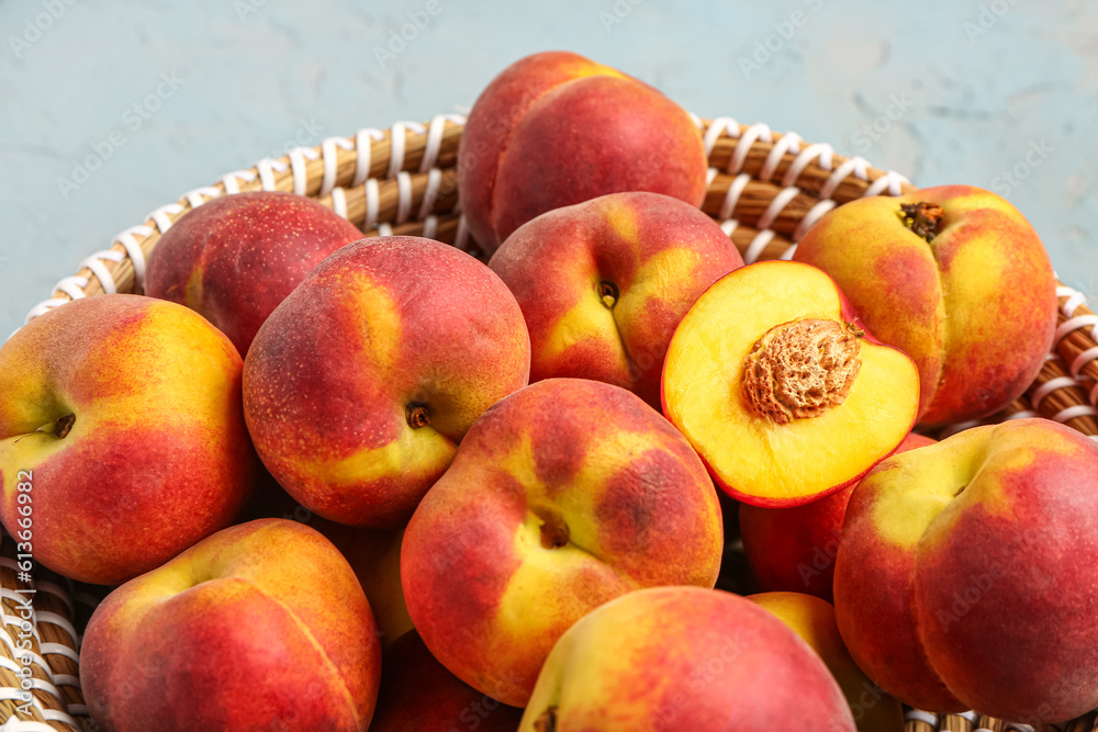 Wicker bowl with sweet peaches, closeup