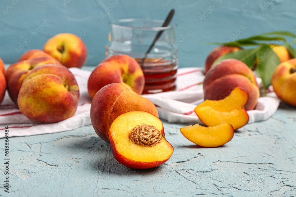 Many sweet peaches on blue background