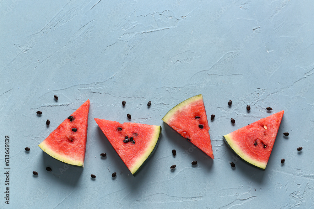 Pieces of fresh watermelon on blue background