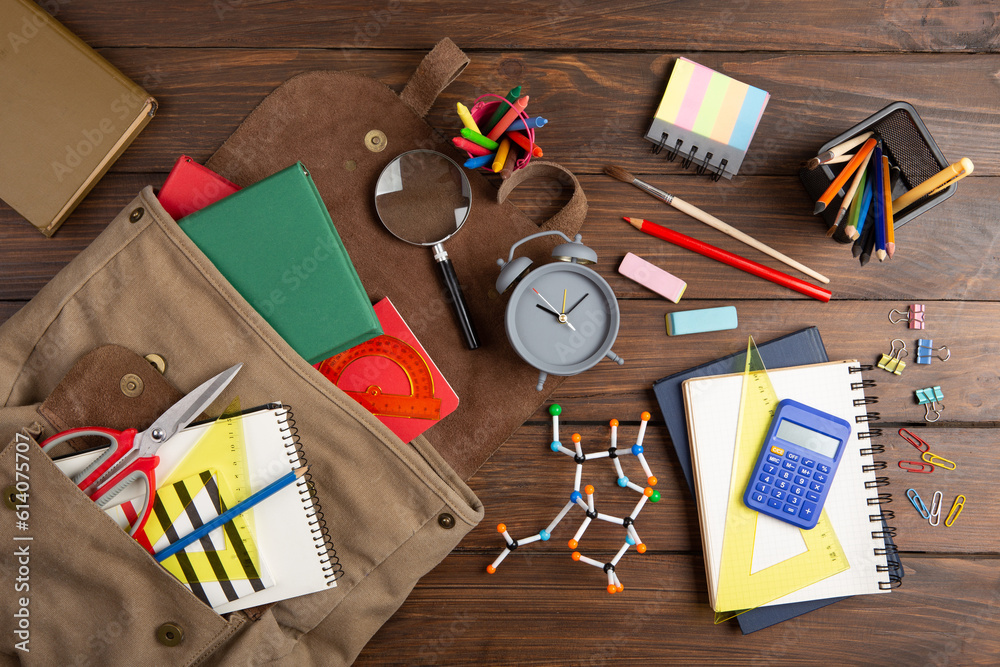 Back to school - books and school backpack on the desk in the auditorium, Education concept.