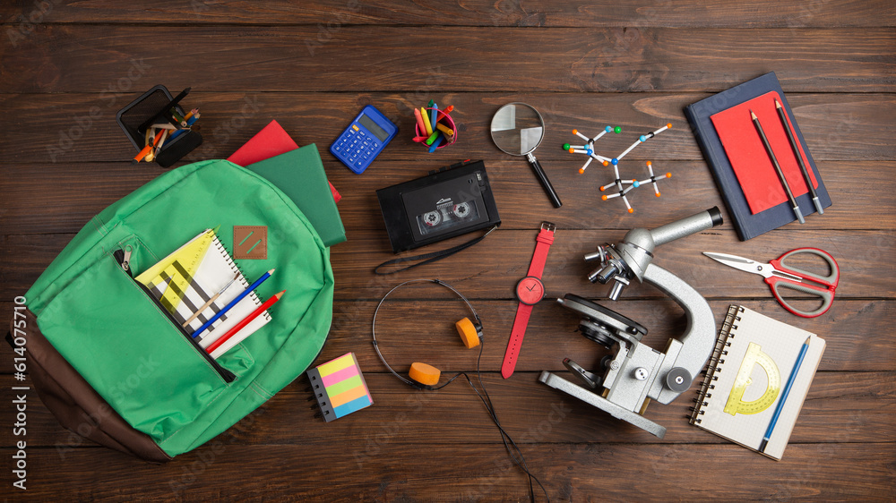 Back to school - books and school backpack on the desk in the auditorium, Education concept.