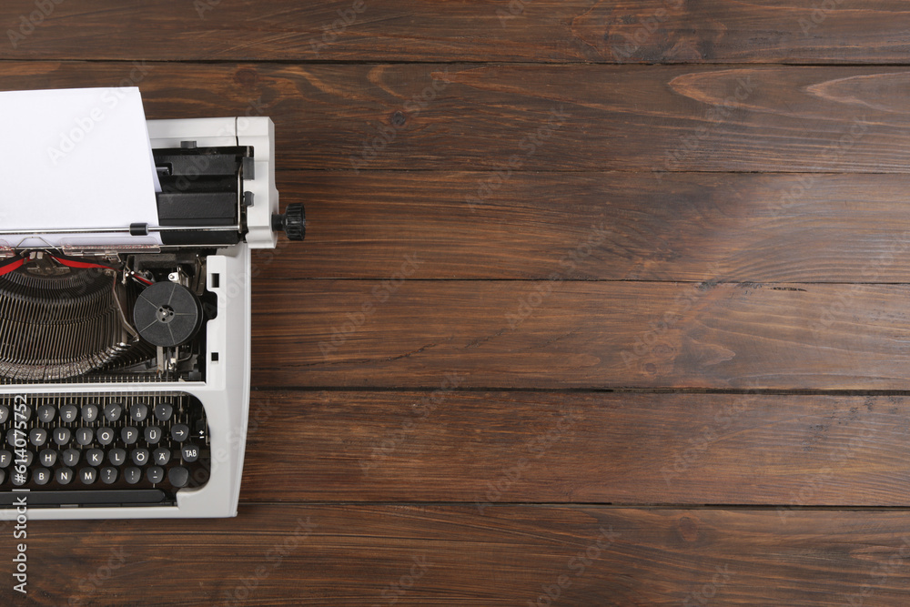 vintage typewriter on the table with blank paper on wooden desk - concept for writing, journalism, b