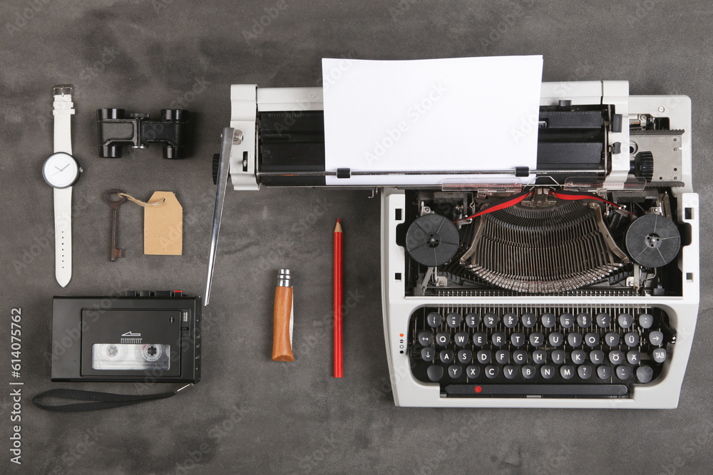 vintage typewriter and tape recorder on the table with blank paper on the desk - concept for writing