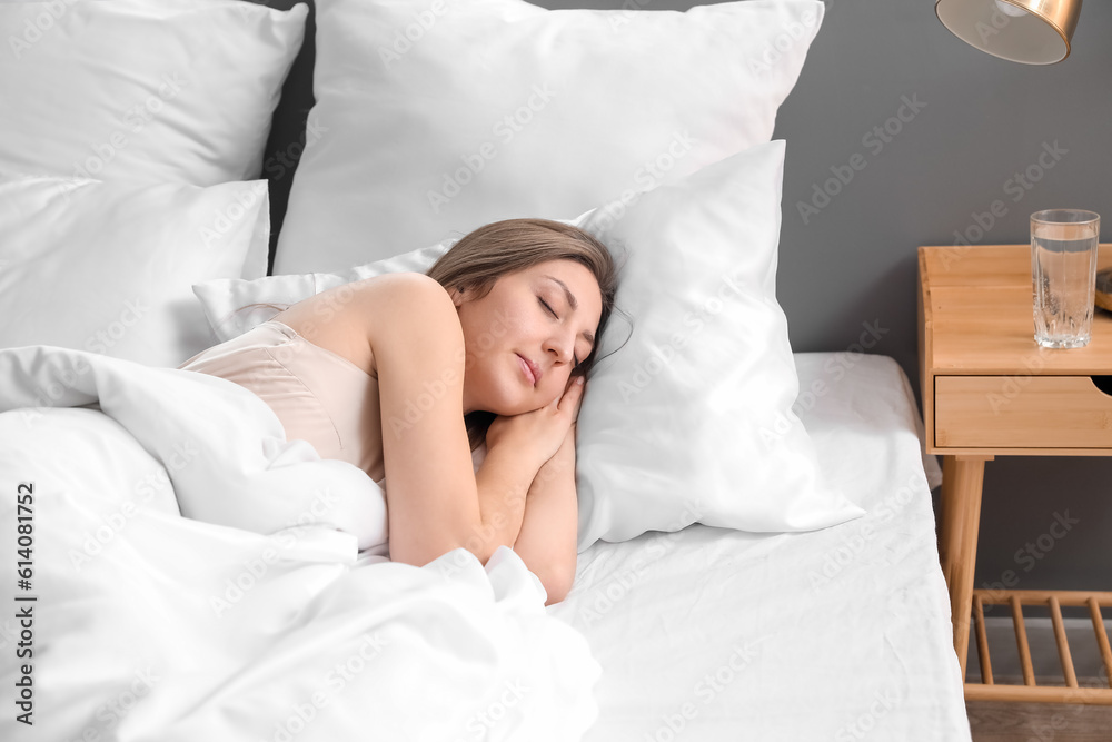 Beautiful woman sleeping in bed at home