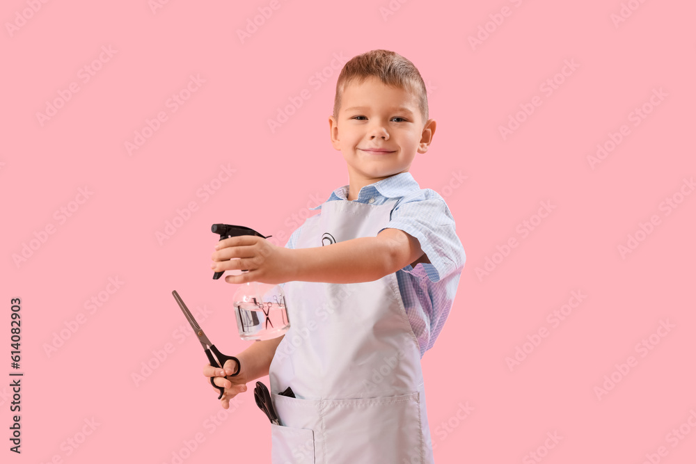 Funny little hairdresser with scissors and spray on pink background