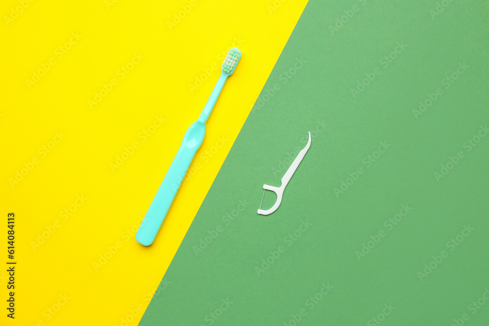 Floss toothpick and brush on colorful background