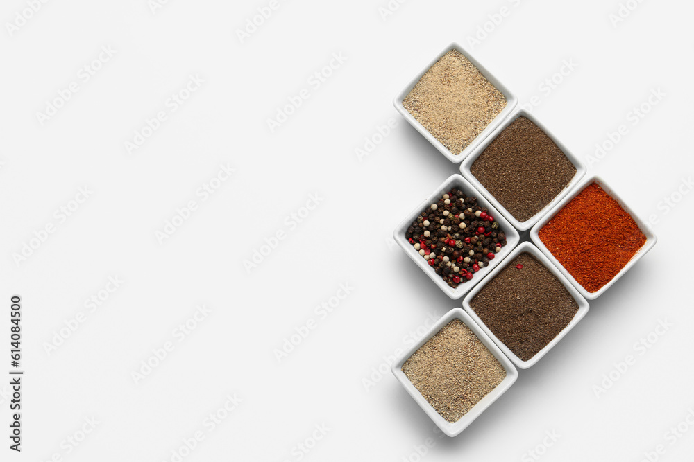 Composition with bowls of fresh aromatic spices on light background