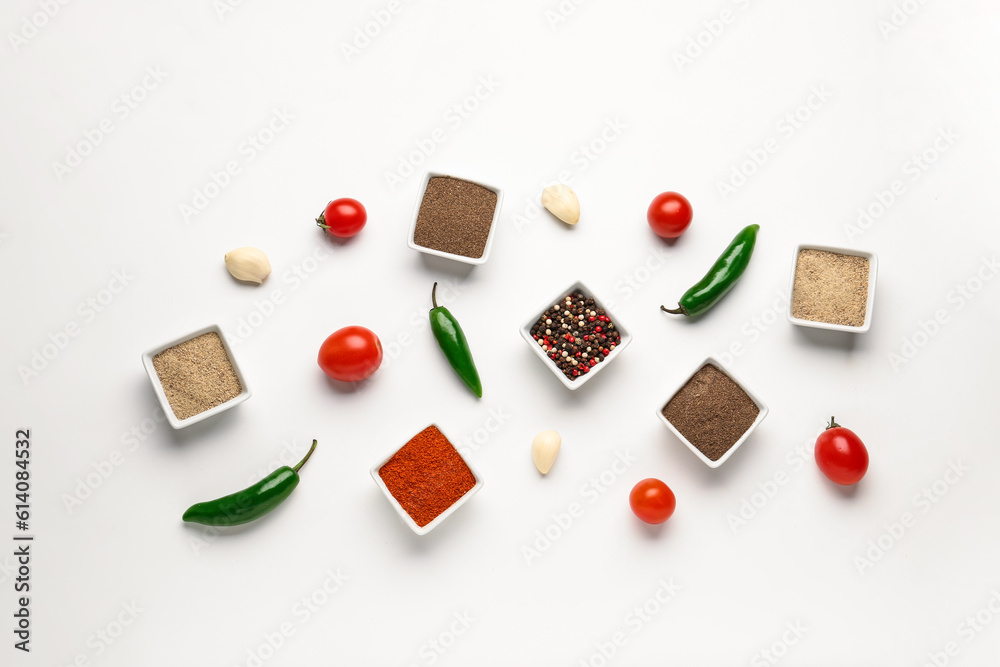 Composition with bowls of fresh spices and vegetables on light background