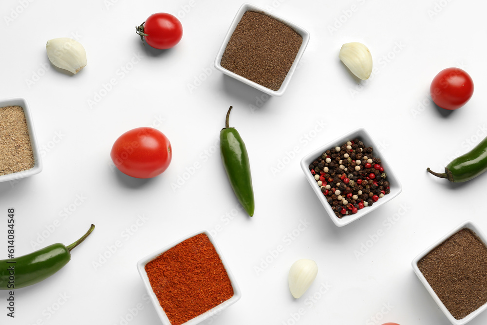 Composition with bowls of fresh spices and vegetables on light background