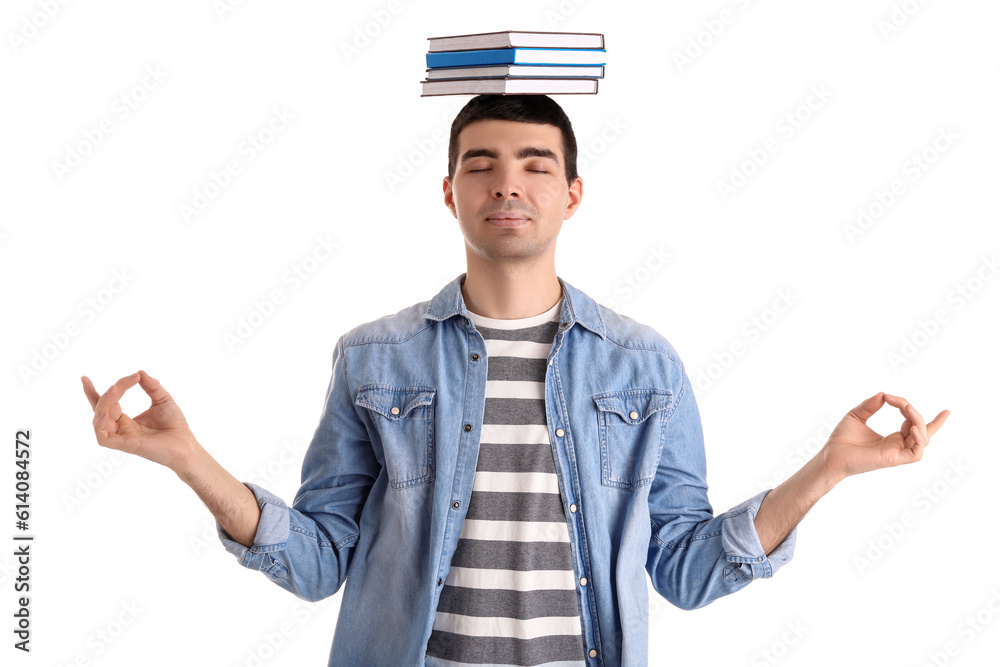 Young man with books meditating on white background. Balance concept