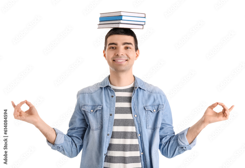 Young man with books meditating on white background. Balance concept