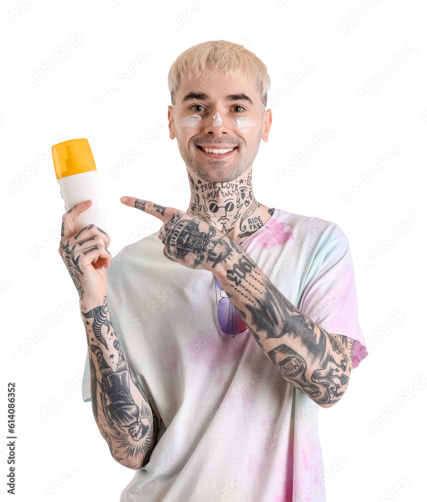 Tattooed man with sunscreen cream on white background