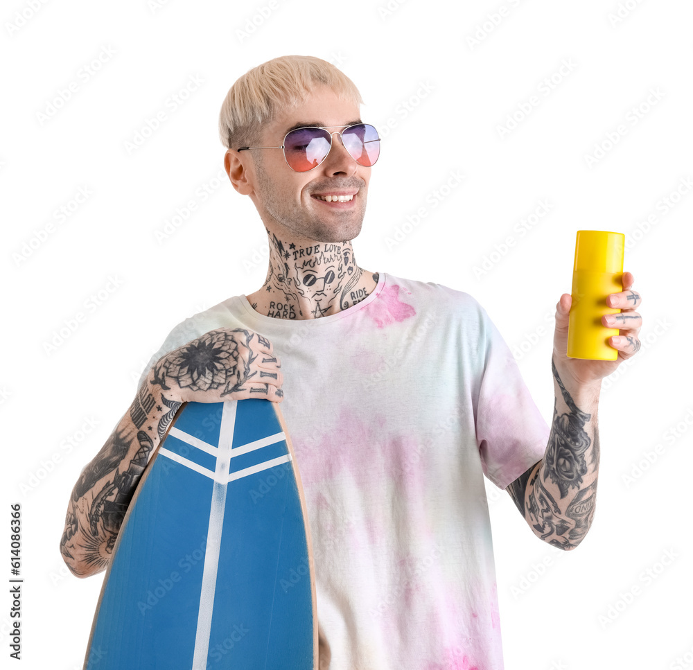 Tattooed man with sunscreen cream and surfboard on white background