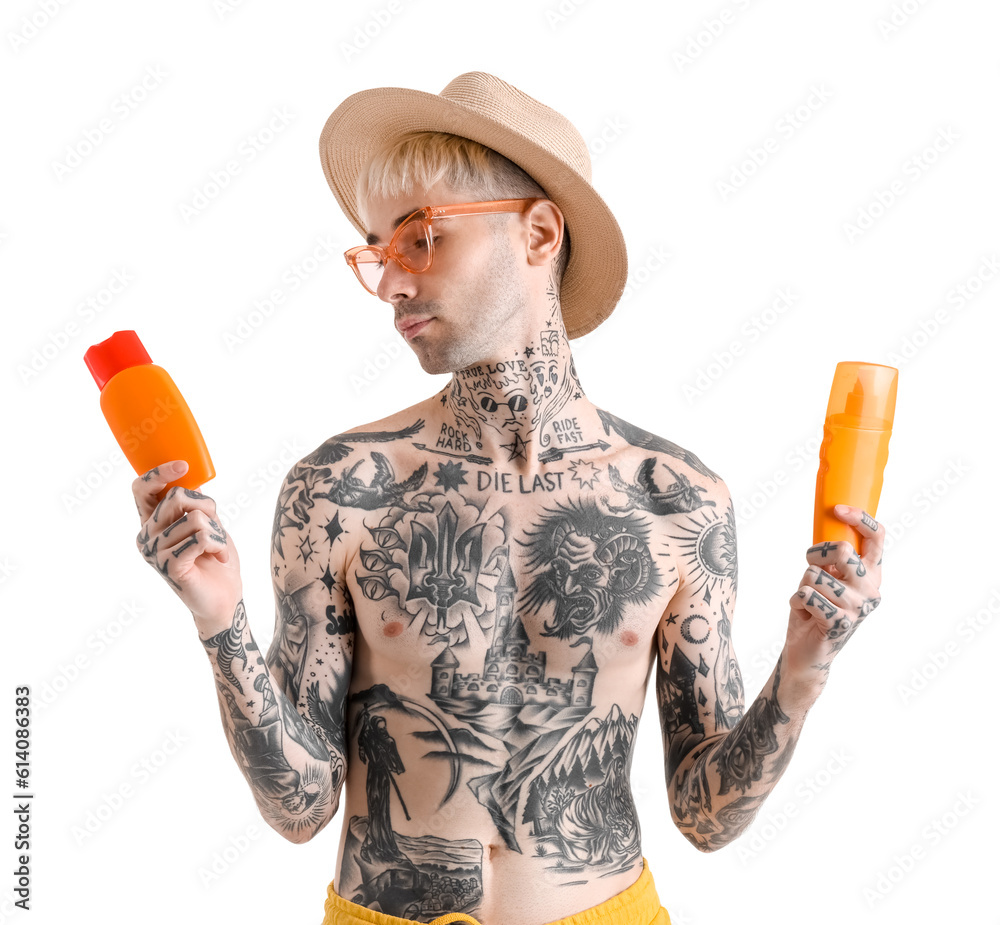 Tattooed man with different sunscreen creams on white background