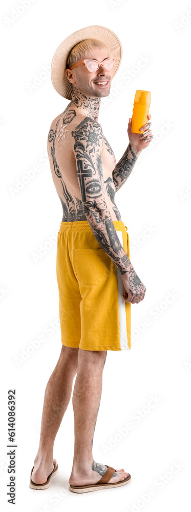 Tattooed man with sunscreen cream on white background