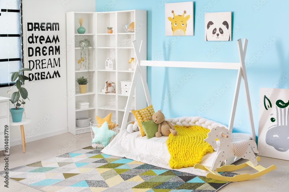 Interior of childrens room with bed, shelving unit and toys