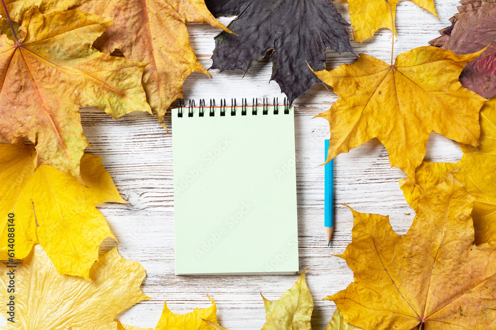 Spiral notepad and pen lies on vintage wooden desk