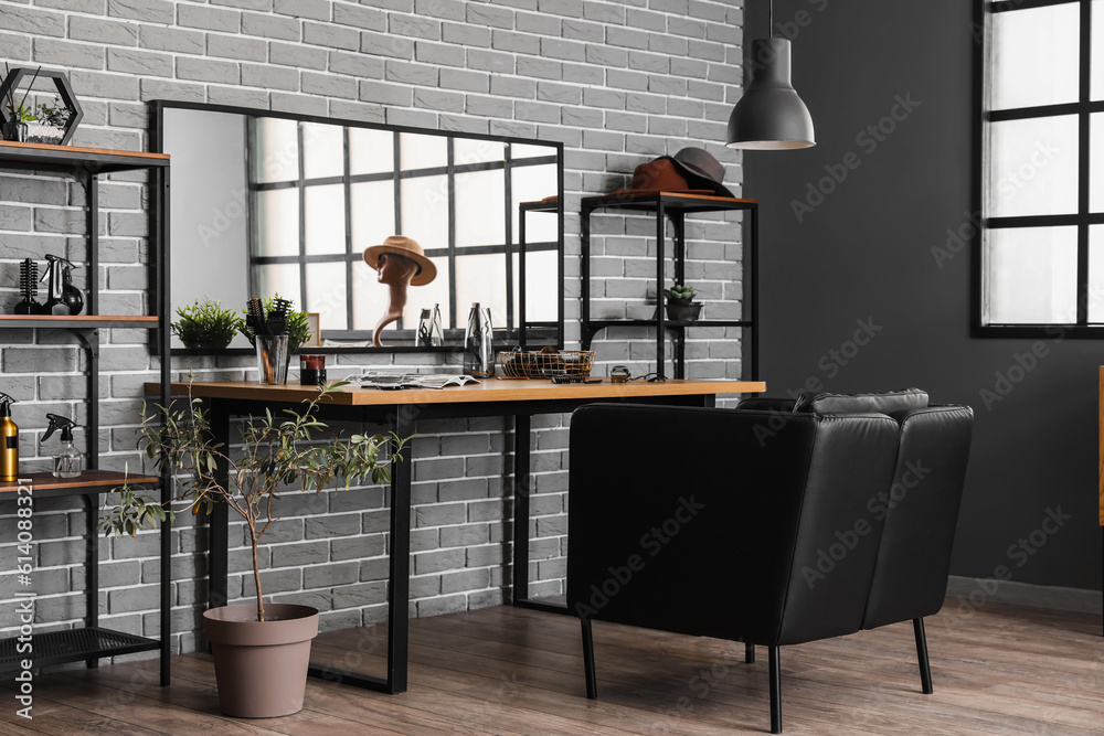 Interior of beauty salon with comfortable armchair, table and mirror