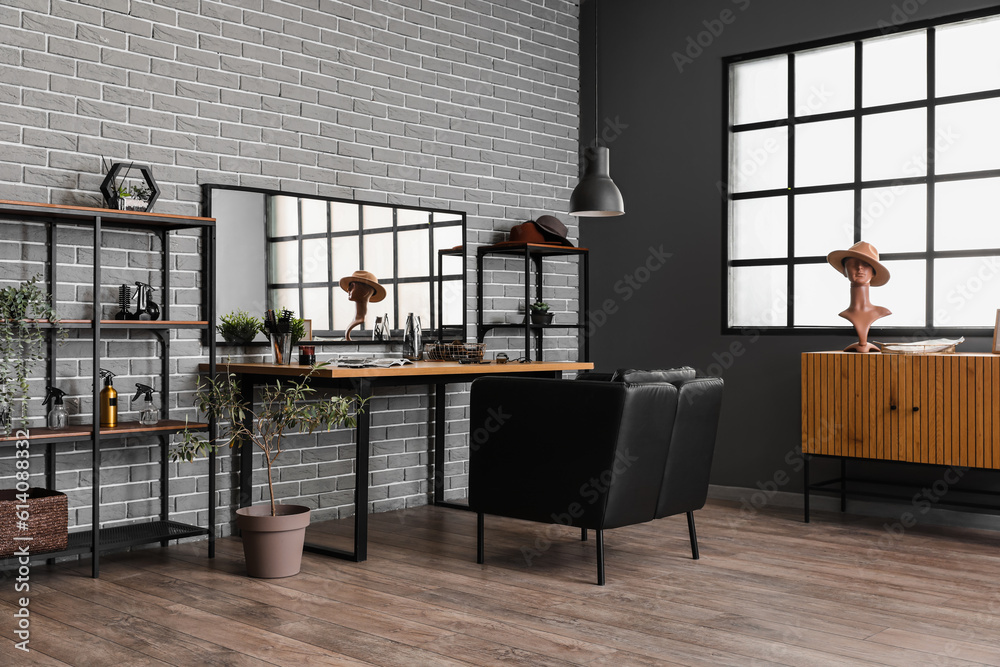 Interior of beauty salon with comfortable armchair, table and mirror