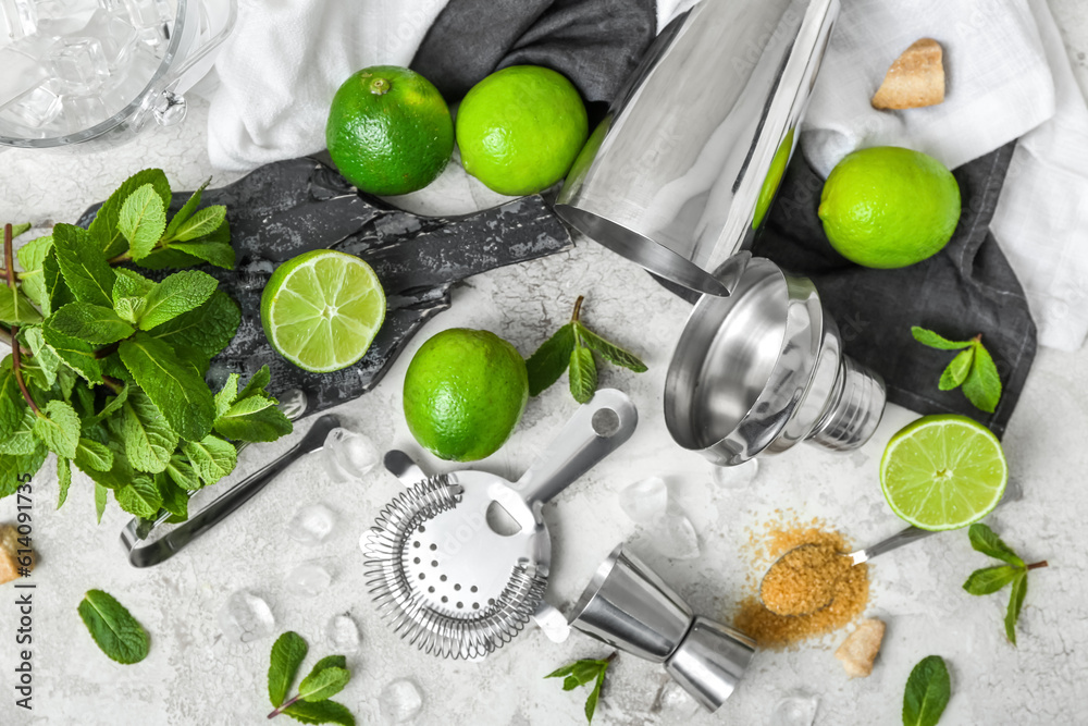 Measure cup, strainer and ingredients for preparing mojito on light background