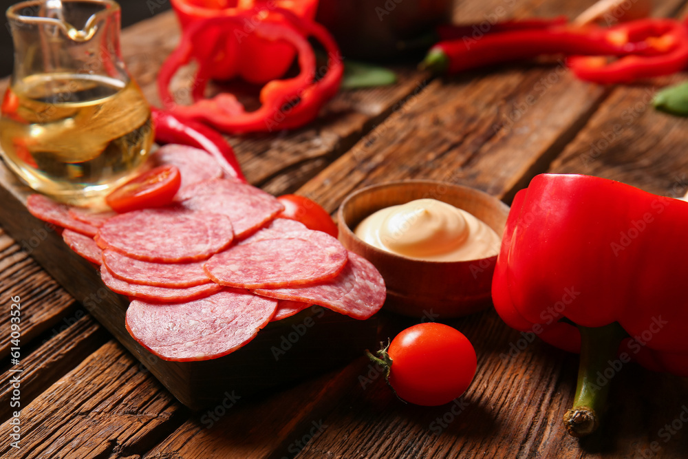 Different ingredients for preparing pizza on wooden background