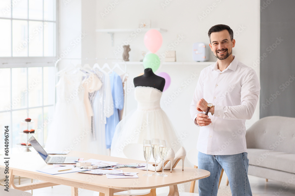 Male wedding planner working in office