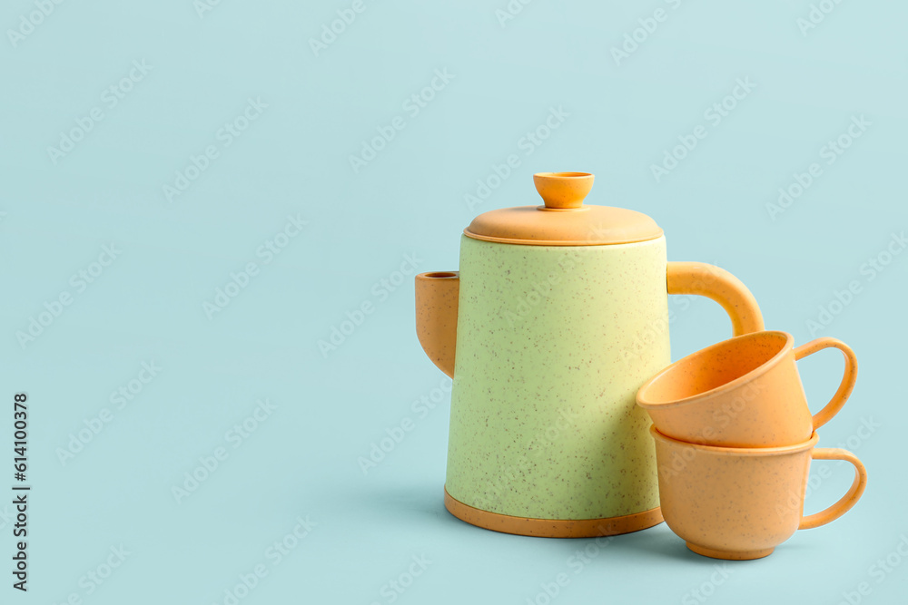 Teapot with cups on blue background. Childrens Day celebration