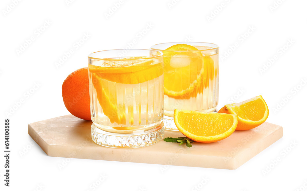 Glasses of infused water with orange slices on white background