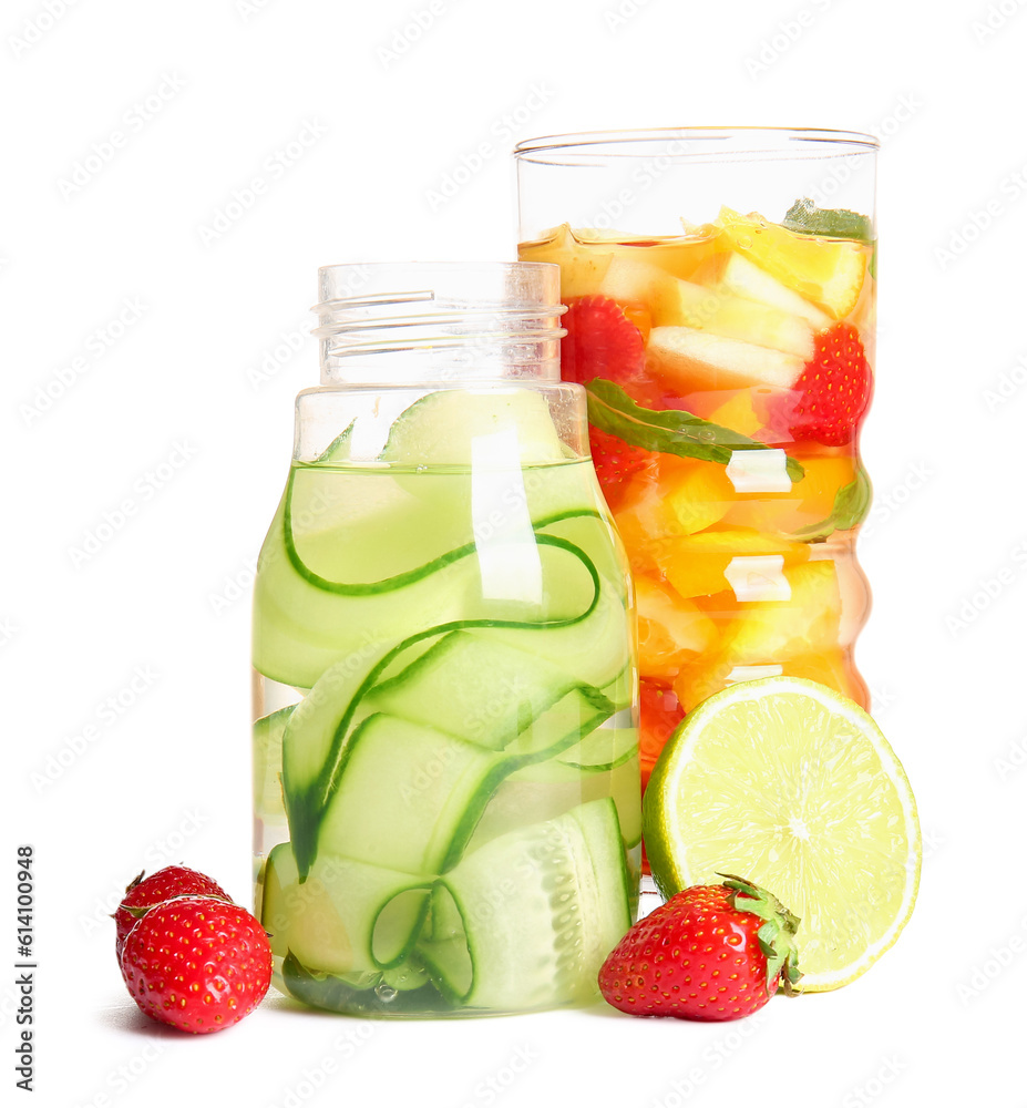 Glass and bottle of infused water with different sliced fruits on white background