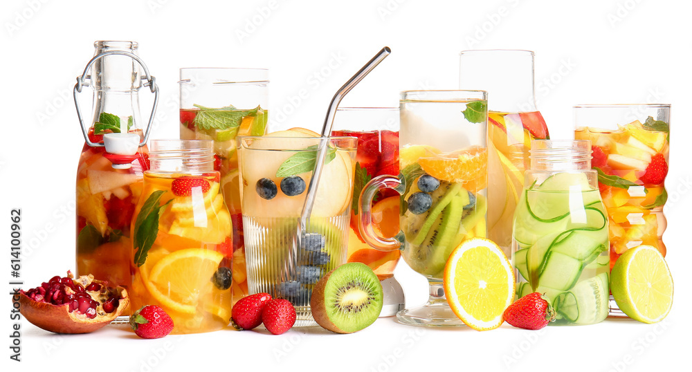 Glasses and bottles of infused water with different sliced fruits on white background