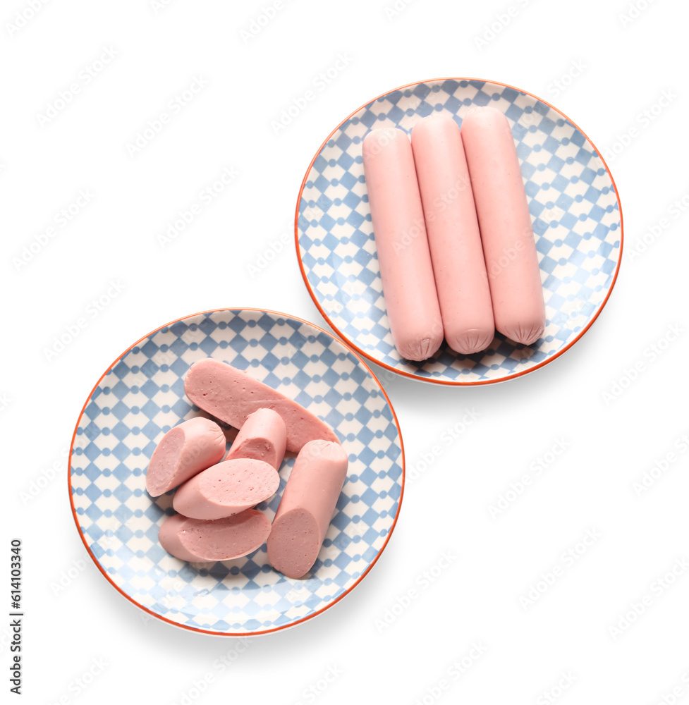 Plates with tasty thin sausages on white background