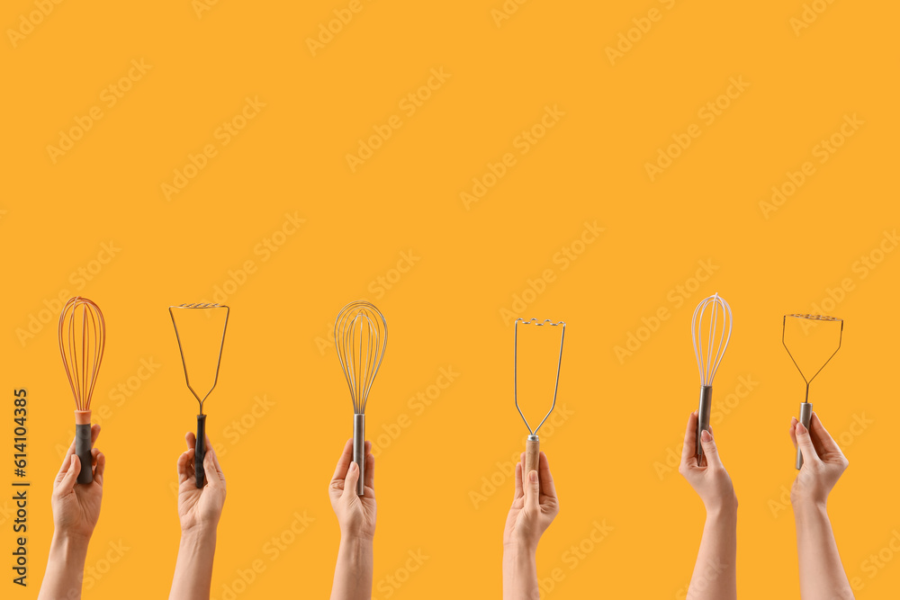 Female hands holding different whisks and mashers on yellow background