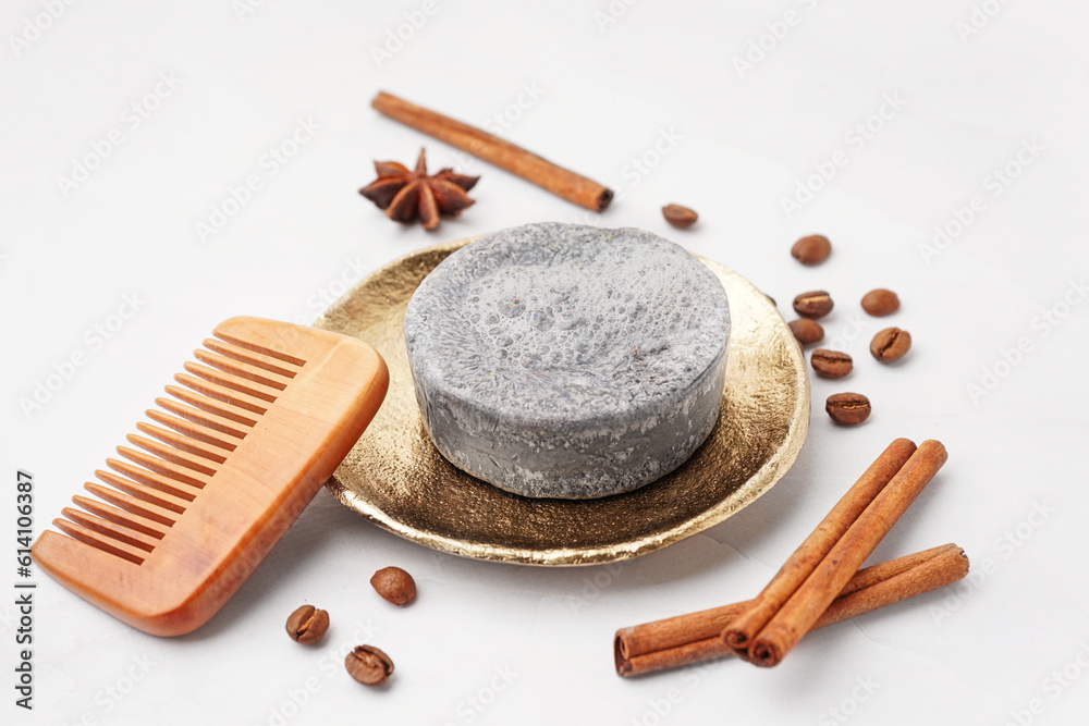 Handmade solid shampoo, hair comb and spices on light background, closeup