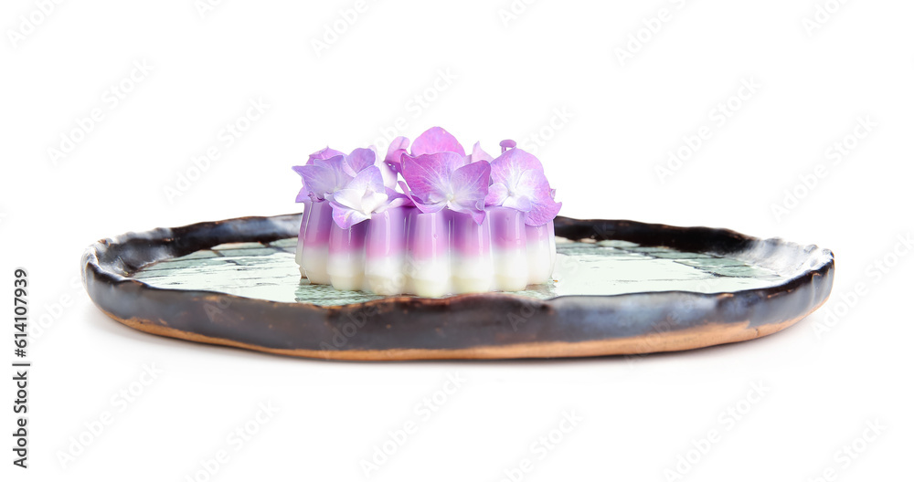 Plate of panna cotta with beautiful hydrangea flowers on white background