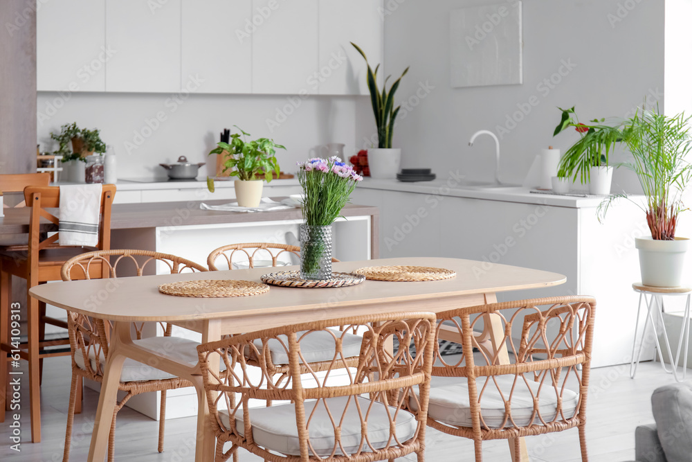 Interior of light open plan kitchen with dining table