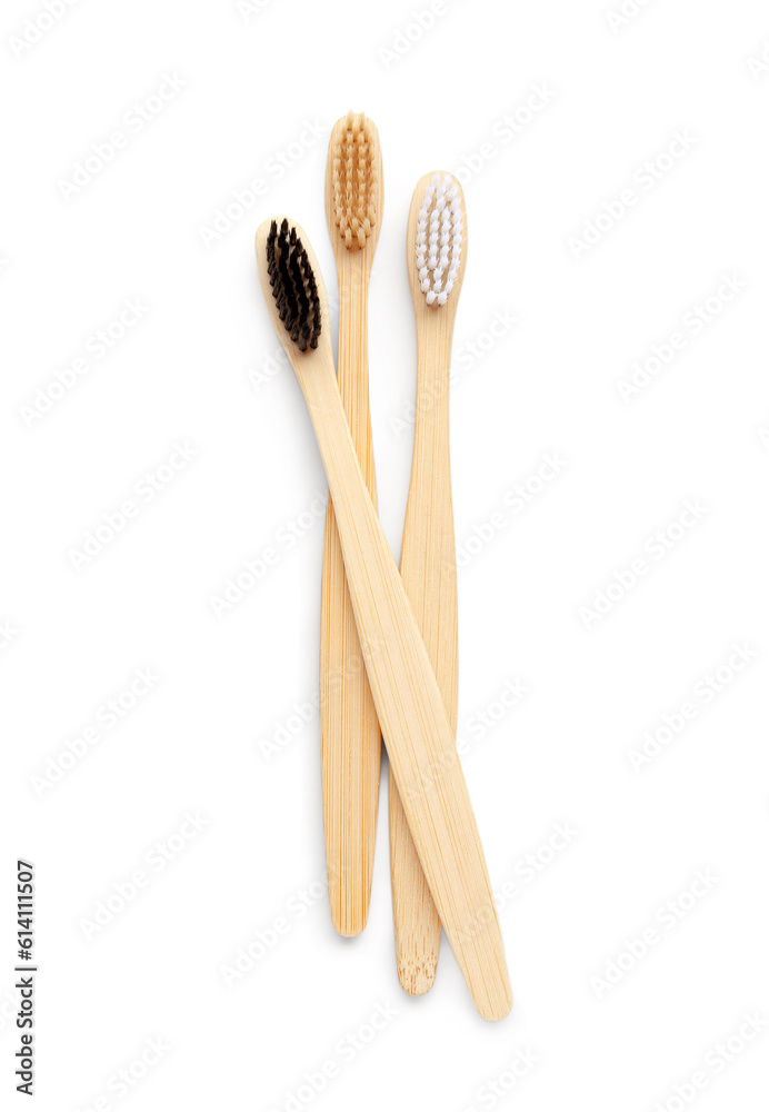 Different bamboo toothbrushes on white background