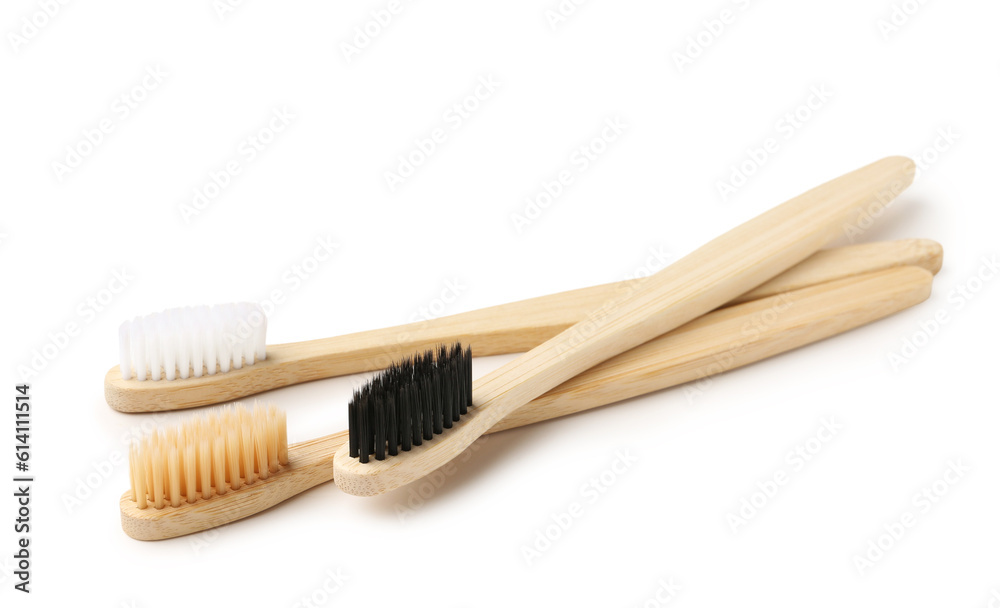 Different bamboo toothbrushes on white background