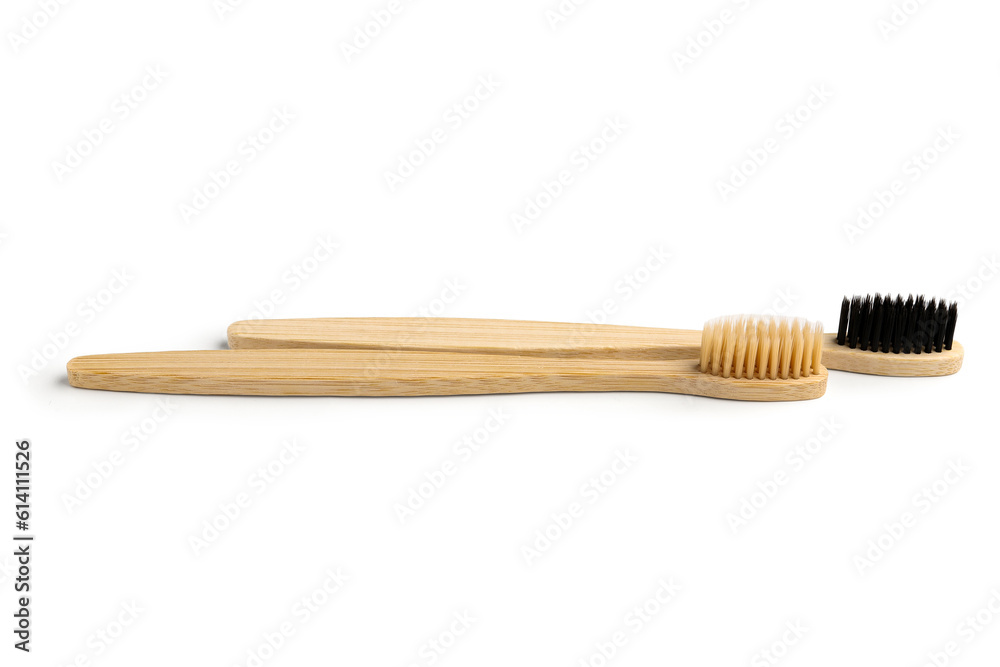 Different bamboo toothbrushes on white background