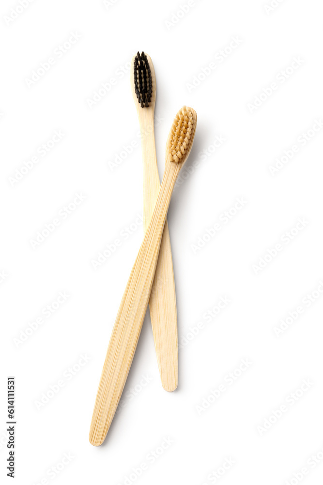 Different bamboo toothbrushes on white background