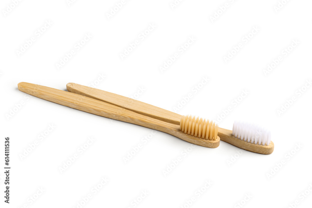 Different bamboo toothbrushes on white background