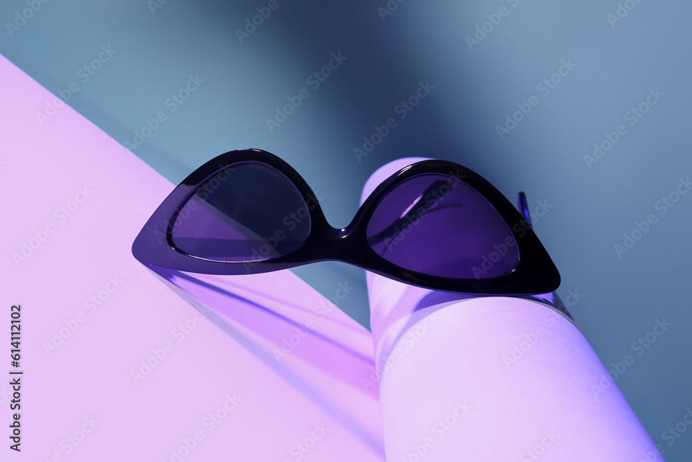 Stylish sunglasses on colorful background