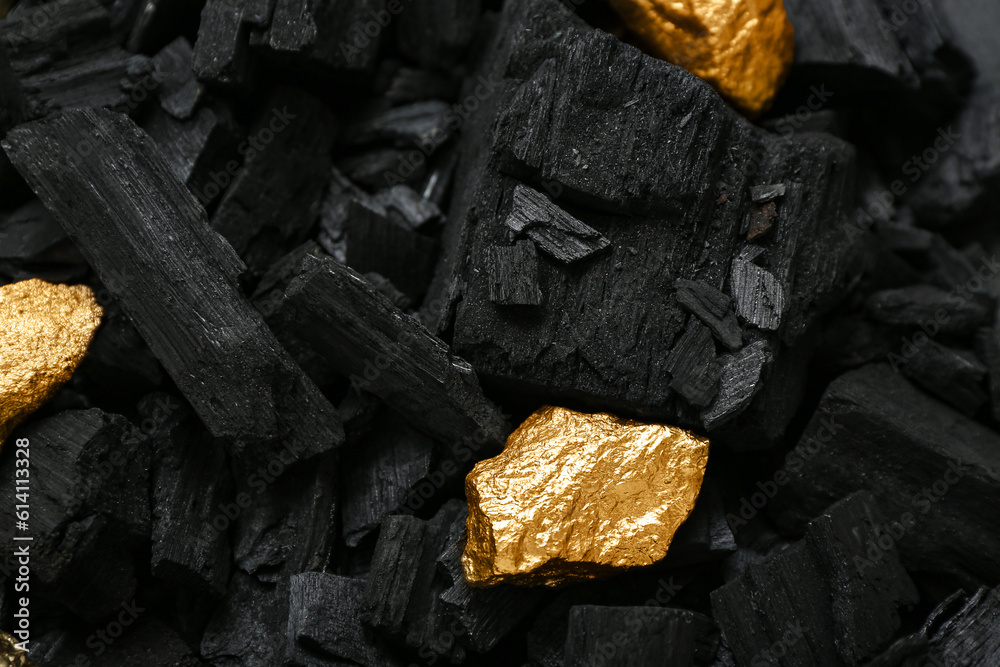 Golden nuggets on black charcoal