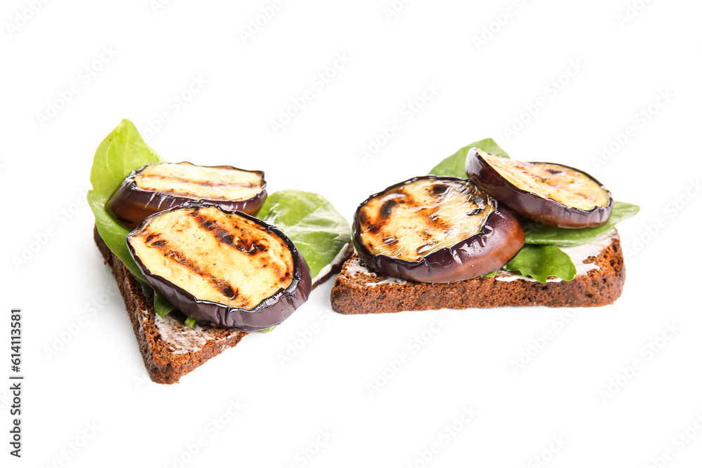 Toasts with delicious grilled eggplants on white background