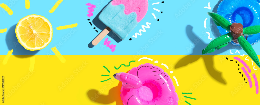 Summer concept with a flamingo float, lemon sunlight and a popsicle - flat lay